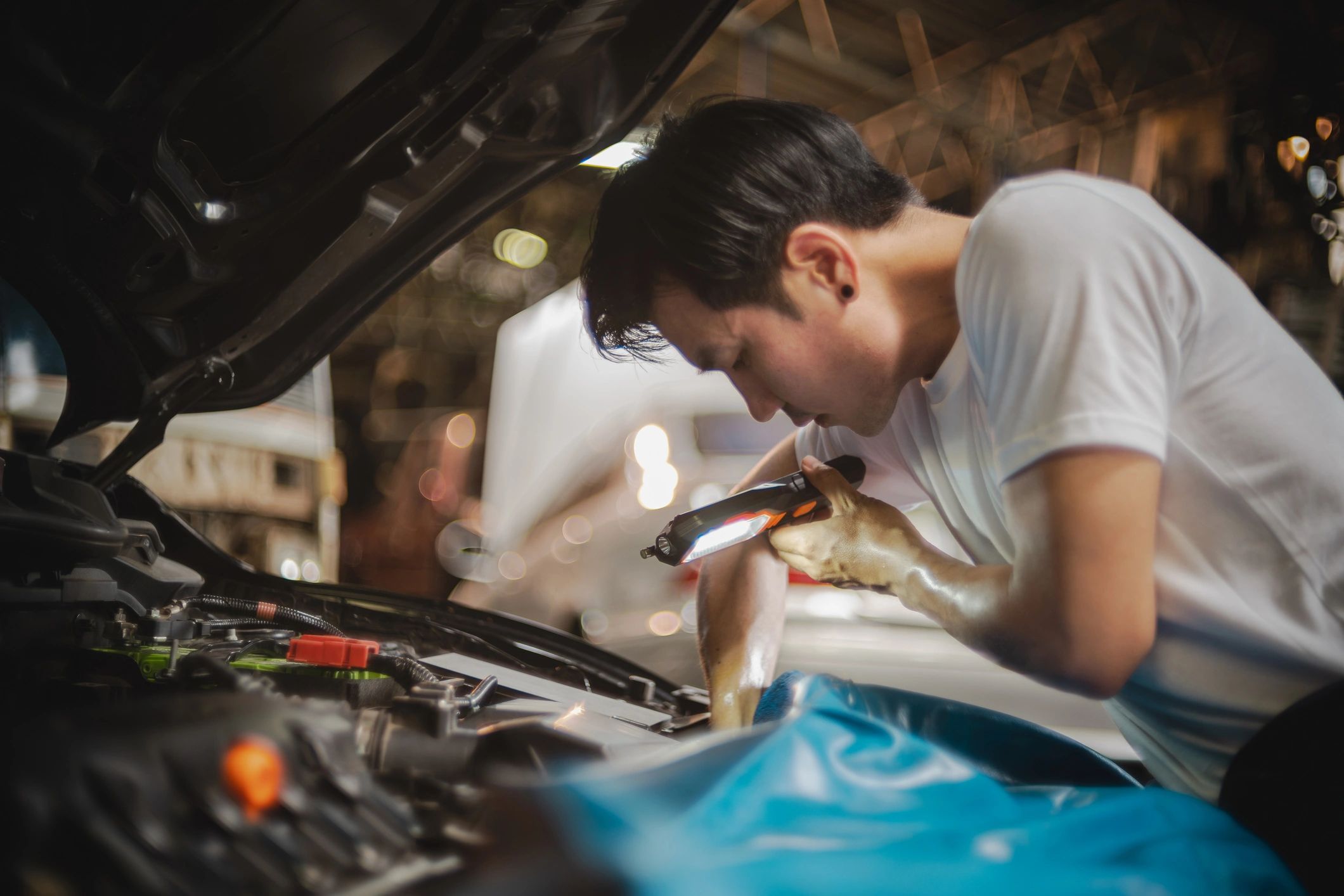 Mechanic checking a car battery under the hood